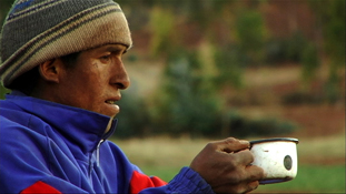Peruvian man drinking from mug