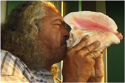 Saba man blowing conch shell